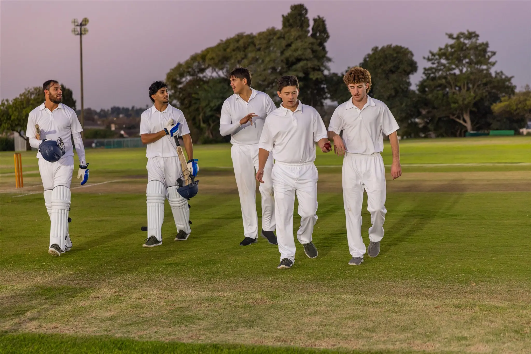 Local cricket team at dusk